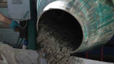 Concrete pouring from a mixer.