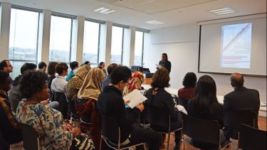 PhD students at conference presentation