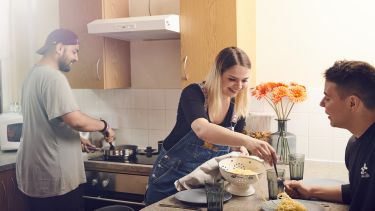 students making pasta in a kitchen 