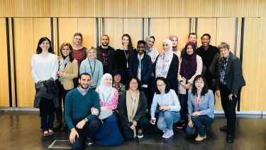 Group of PhD students and staff at social event