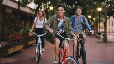 Students laughing on bikes