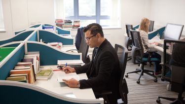 A student working at a desk - image
