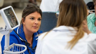 A nursing student with a clinical skills tutor