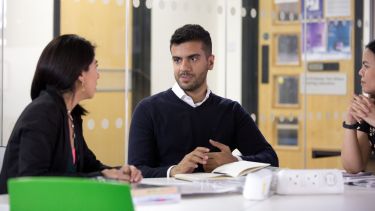 Student discussing work with a fellow student or supervisor