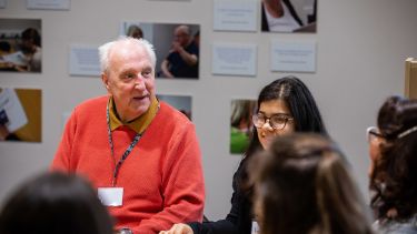 A group of Health Sciences students working with an elderly man. 