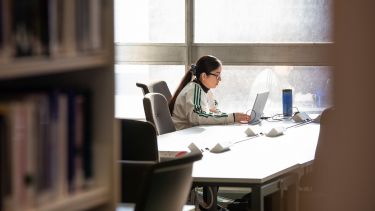 A student working in the Health Sciences Library.
