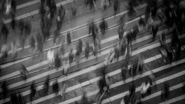 Black and White Photo of People Crossing The Road