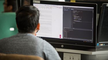 Computer Science student working at a computer