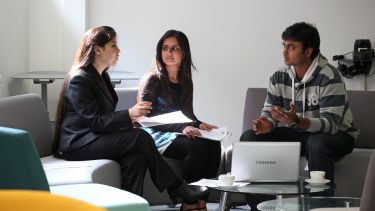 Three Computer Science students in discussion. 
