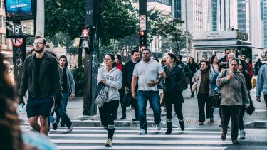 People crossing a city street.