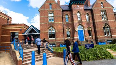 Bartolome house, students walking