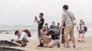 Students taking photographs of their surroundings whilst on a field trip to the Galapagos Islands