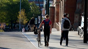 Students wheeling a bike