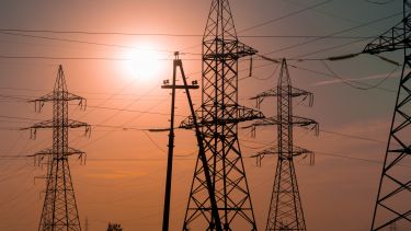 Energy pylons and a sunset - image