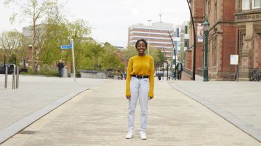 a student in a yellow jumper is stood near Jessop West