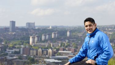 A photo of Carlo in front of the city scape 