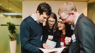 Alumni volunteers with students at an employability event