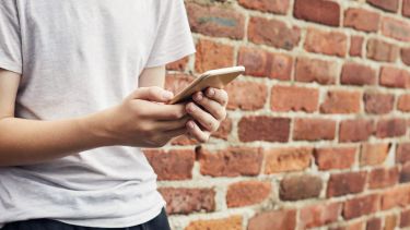 A photo of a person using their phone.