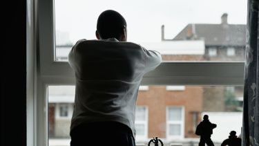 A man looking our of a window