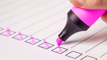 Checklist, highlighter ticking tasks off a checklist