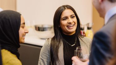 A student talking to alumni volunteers at our London City Connections event