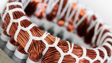A close up of an electric motor stator and winding stack
