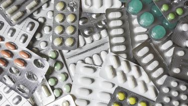 Lots of medication, pills and lozenges, in a pile - image