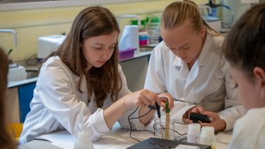 Two students conduct Geography practical in labs with test tubes