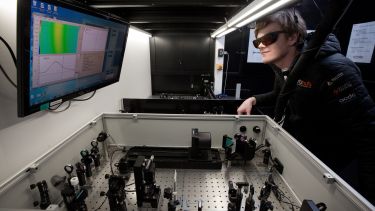 A researcher at the transient absorption station in the Ultrafast Laser Spectroscopy Laboratory