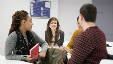 A group of students sat together talking