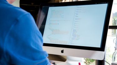 person at a computer writing code