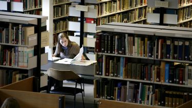 student sat in library studying