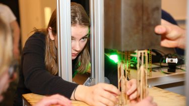 A female mechanical engineering testing a structure in the lab