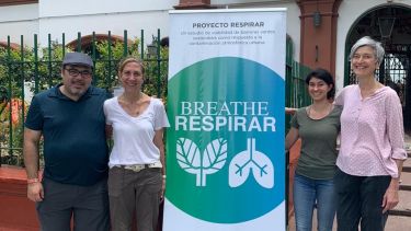 Miguel Kanai and team standing with a banner promoting their project