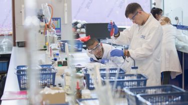 Students preparing aspirin at a Chemistry taster day.
