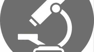 A grey circular icon with an image of a microscope