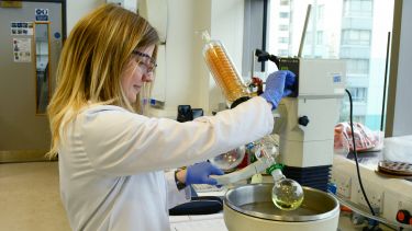 A researcher performing a catalysis experiment.