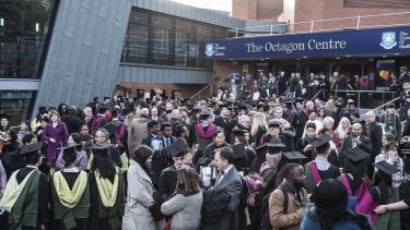 Graduates outside The Octagon Centre at graduation.
