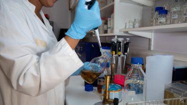 A female student working with equipment in the reproductive medicine lab.