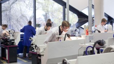 Several researchers working in The Diamond. They are all wearing lab coats.