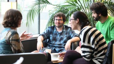 A group of Philosophy students chatting in a cafe.