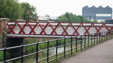 Bridge over the River Don with footpath and wild flowers.