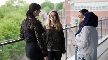 PG Students on balcony of Students Union