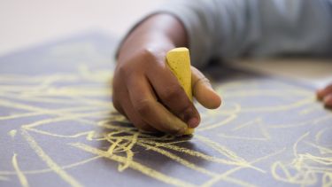 Photograph of young person drawing
