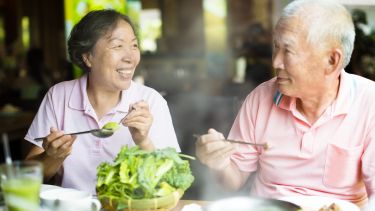 Photo of happy Senior Couple Enjoying hot pots In Restaurant