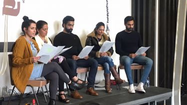 A panel sat in front of an audience