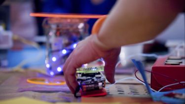Photograph of yound person working with circuitry