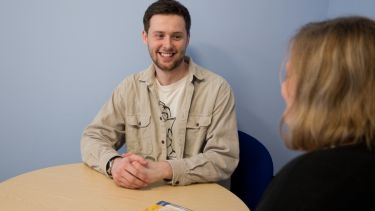 Student speaking to professional services staff in the department of politics and international relations
