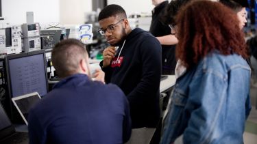 ACSE students and technicians work together