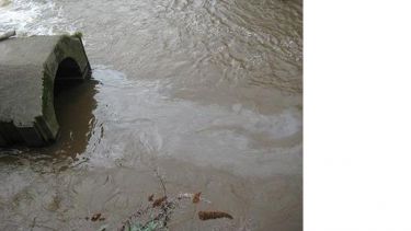 Polluted water entering a pipe